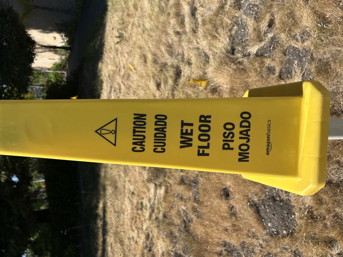 Amazon Basics wet floor sign — EXHIBIT B — CAUTION CUIDADO WET FLOOR PISO MOJADO